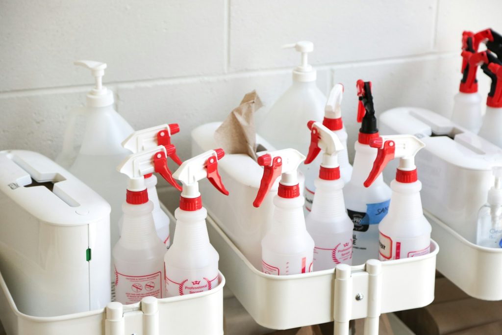 Cleaning bottles neatly arranged in a white caddy